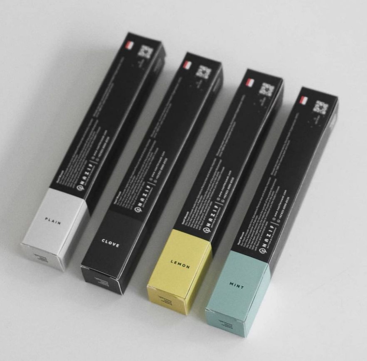Four Nazif miswak boxes in plain, clove, lemon and mint